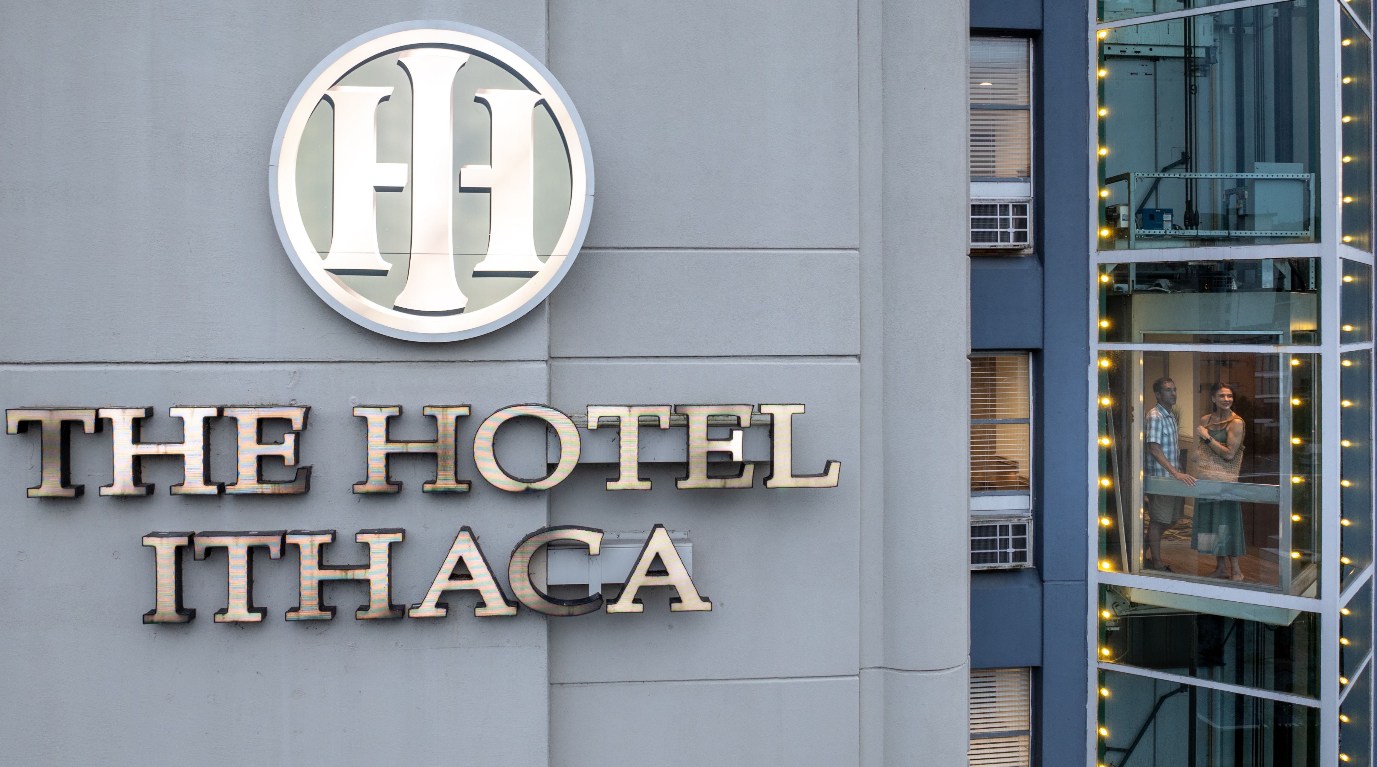 A couple rides the elevator up the outside of The Hotel Ithaca in Ithaca New York