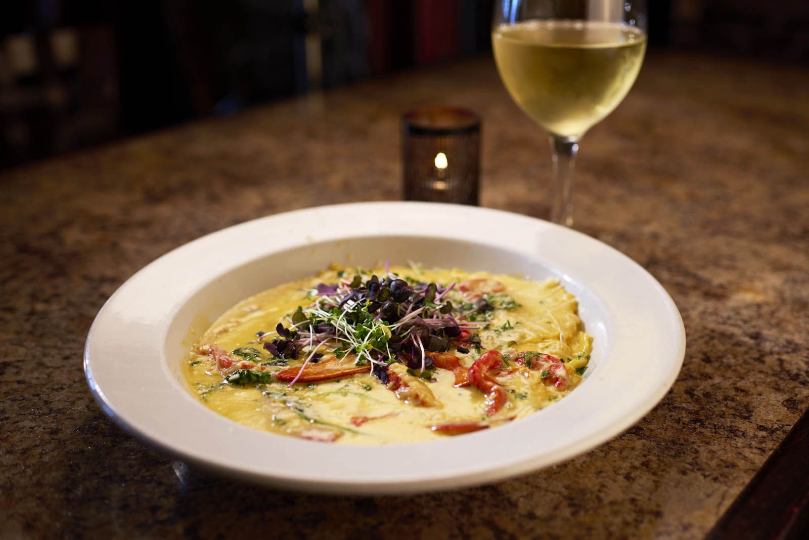 A ravioli pasta dish with colorful garnishes at the Lakehouse Tap & Grille