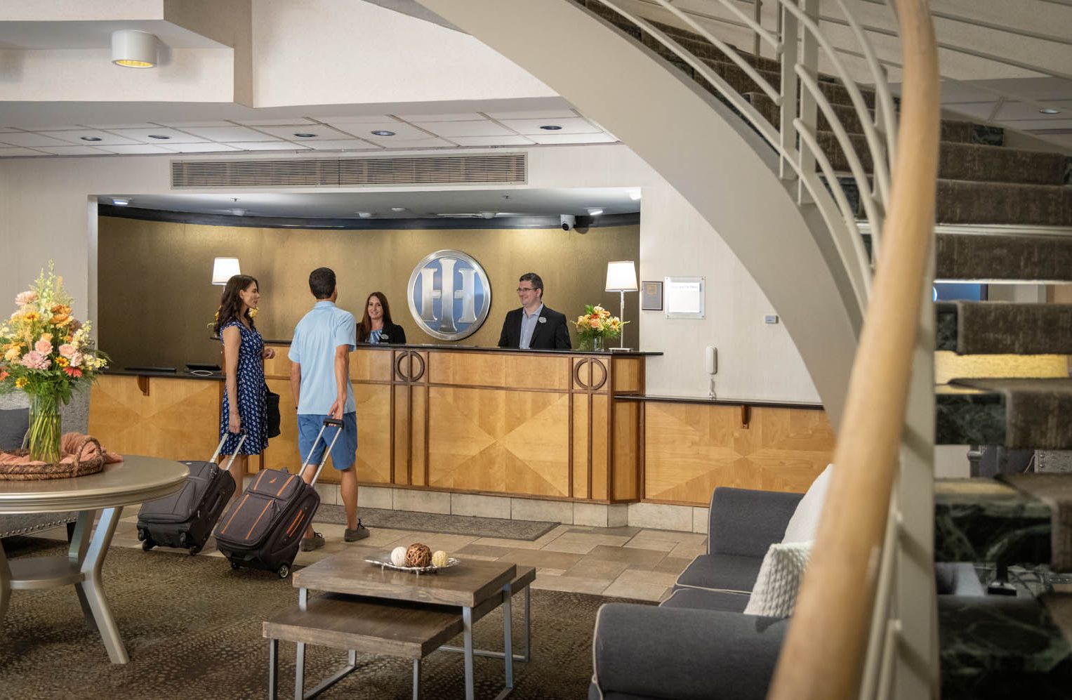 A couple checking in at the lobby of The Hotel Ithaca