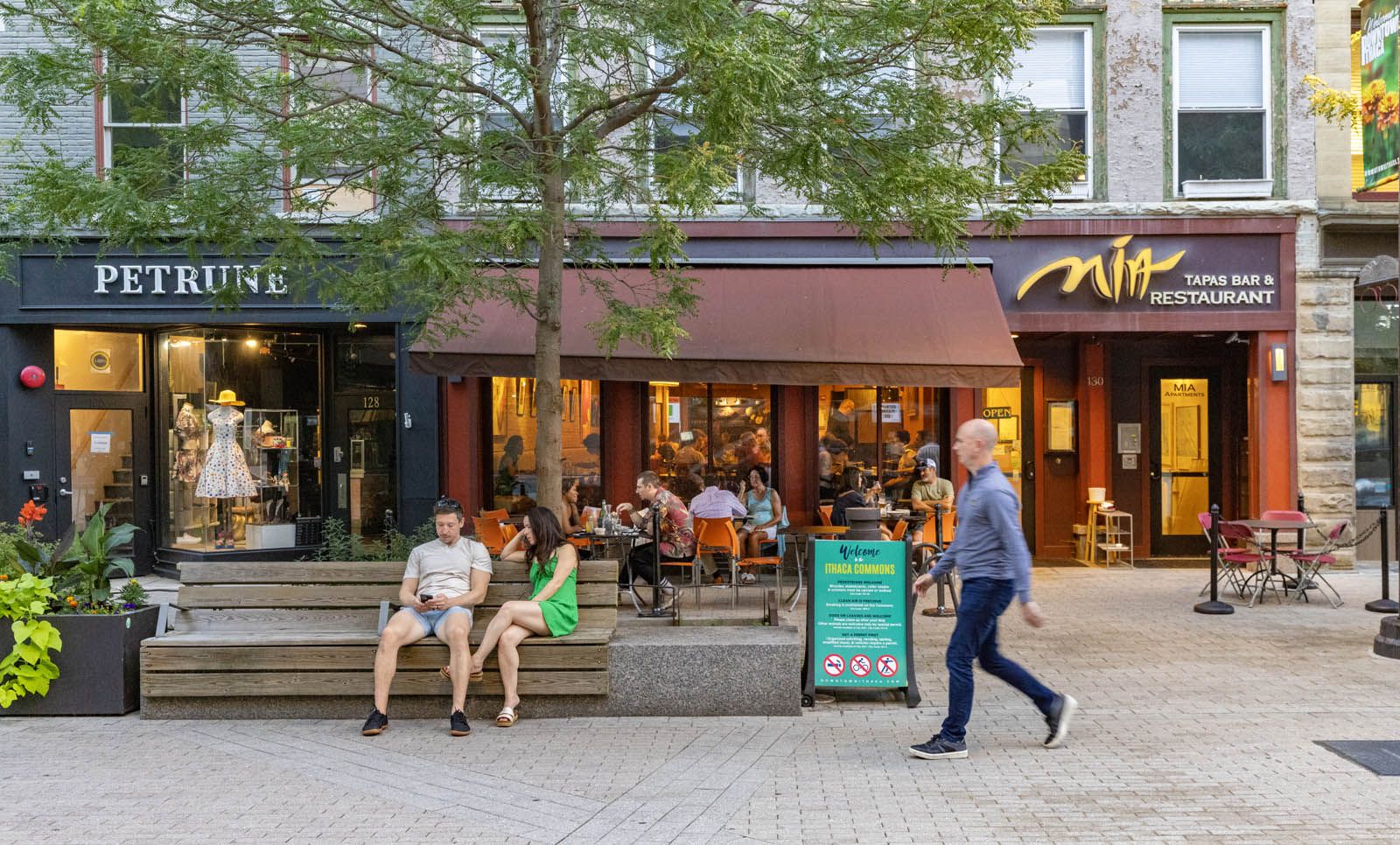 Pedestrians walk along Ithaca Commons, a popular shopping destination in Ithaca