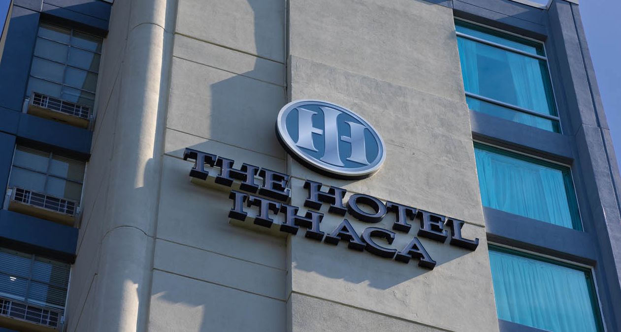 The exterior of The Hotel Ithaca with the hotel's logo front and center