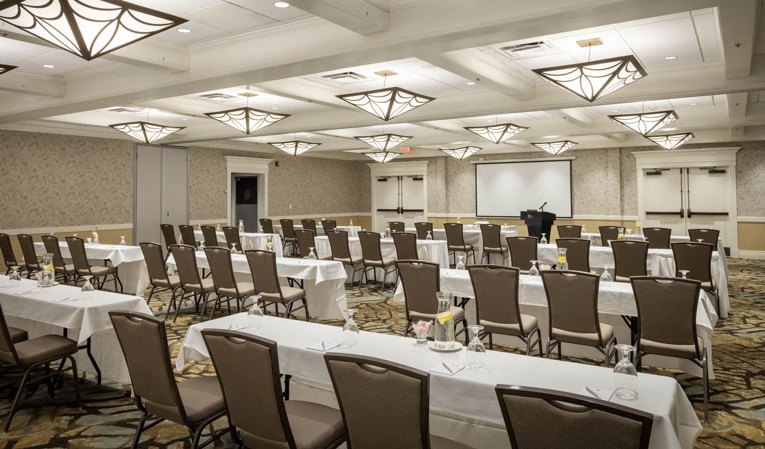 A large conference hall with rows of empty chairs ready for a meeting