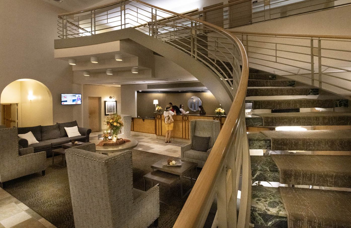 The expansive lobby of The Hotel Ithaca, with guests checking in